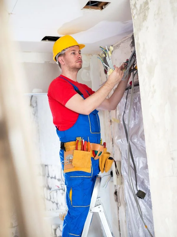 Ein Elektriker arbeitet an einem Schaltkasten